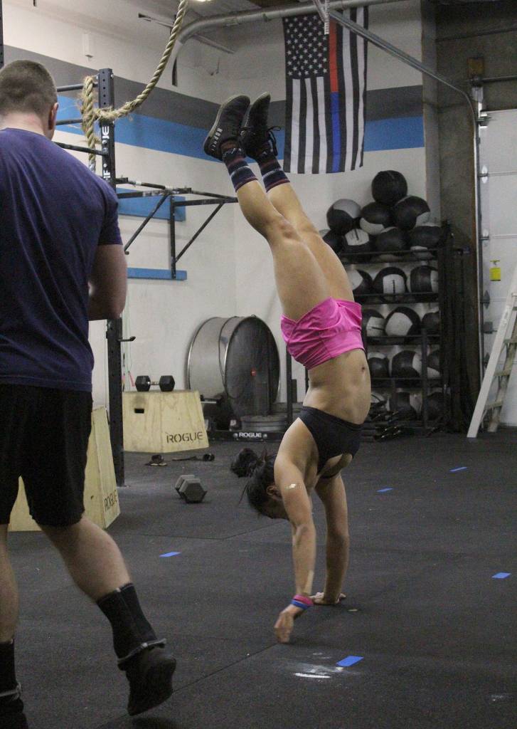 Amber Takara was one of the only athletes who made it to the final exercise of handstand walks at the March 8 Friday Night Lights event. Olivia Sullivan/staff photo