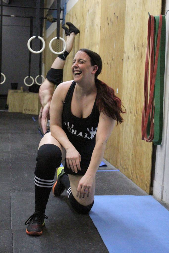 RaeAnna Devey Riding laughs off her handstand push-ups at CrossFit Federal Ways Friday Night Lights on March 8. Olivia Sullivan/staff photo