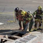 City of Puyallup council member Julie Door ventilates a rooftop with a chainsaw on March 22. Photo courtesy of Craig Soucy