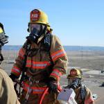 Mirror reporter Olivia Sullivan and SKFR firefighter Jacob Czekanski, right, ascend a seven-story ladder to a rooftop at Fire Ops 101 on March 22. Photo courtesy of Craig Soucy