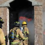 Members of Team C at Fire Ops 101 enter a burn building simulation where temperatures inside exceeded 1,000 degrees Fahrenheit. Photo courtesy of Craig Soucy