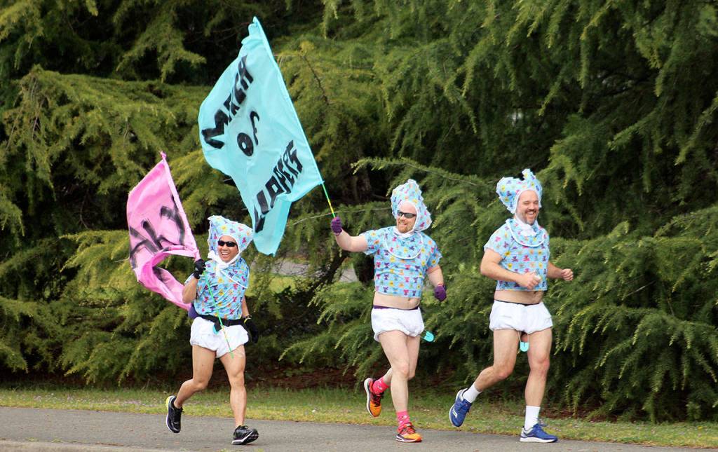 Diaper clad Ted Colby, center, runs along South 320th Street from Hoyt Road to SKFR Station 64 for the March of Diapers. Olivia Sullivan/staff photo