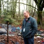 Federal Way communications coordinator Tyler Hemstreet standing in a vacated homeless encampment during a walk-through with Special Operations Unit officers and Mirror staff in January. Olivia Sullivan/staff photo