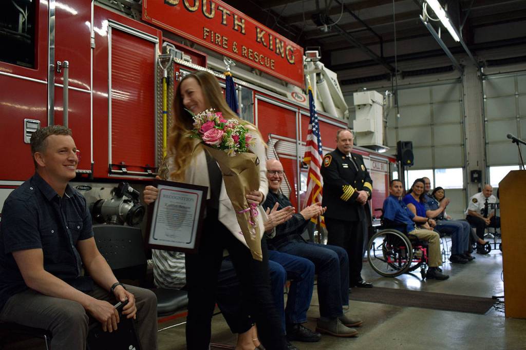Kaitlyn Benson after receiving her award from SKFR for her heroic actions and a bouquet of roses from the Barco Family. Haley Donwerth/staff photo