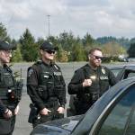 Federal Way police officers are given instructions about the Pursuit Immobilization Technique (PIT) training course before trying it themselves at their Emergency Vehicle Operation Course training training on April 12 at Emerald Downs. Haley Donwerth/staff photo