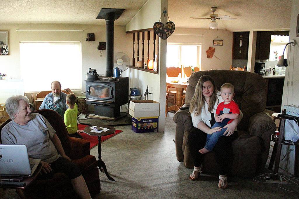 Cindy Lu Vaughn, left, sits in her living room as a longtime friend, Mary Elizabeth, visits with her son and nephew. Olivia Sullivan/staff photo