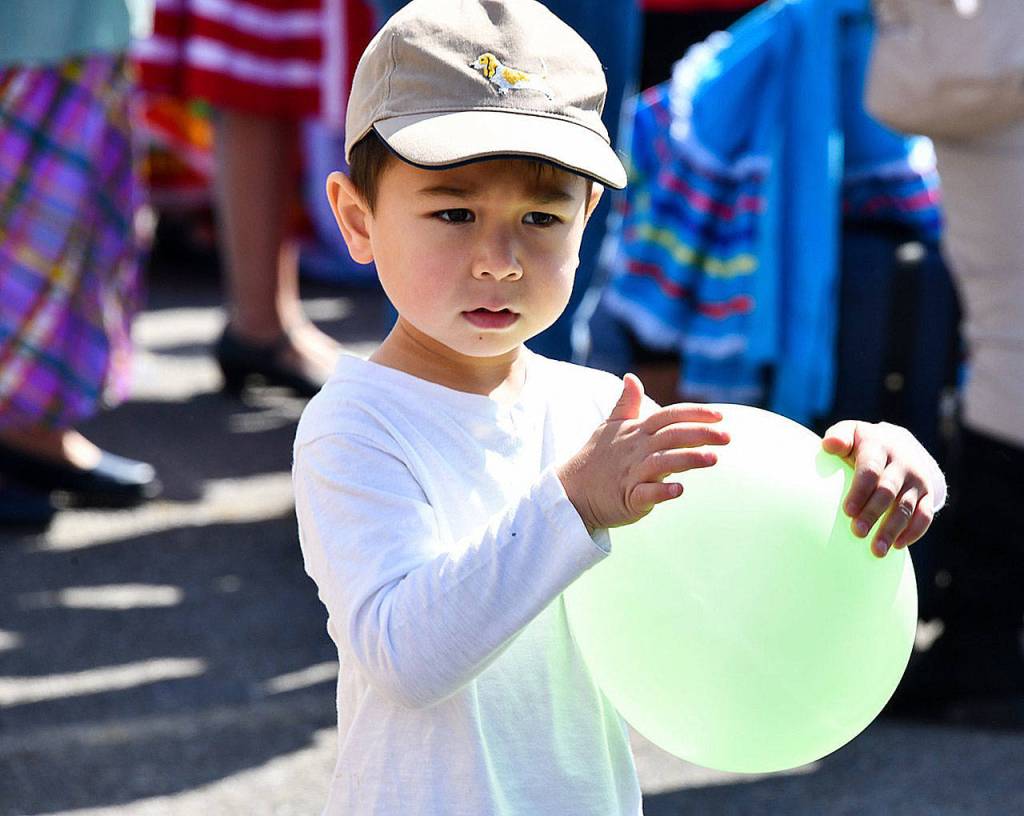 A little boy holds a balloon during the farmers market festivities. Photo courtesy of Shelley Pauls