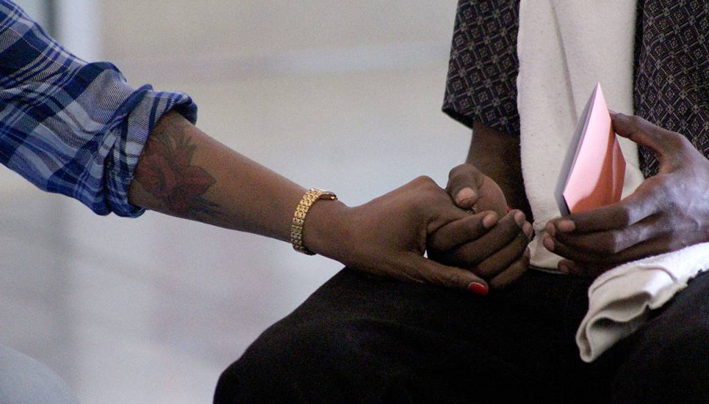 Rochelle Wilson holds her sons hand during Fridays healing circle. Olivia Sullivan/staff photo