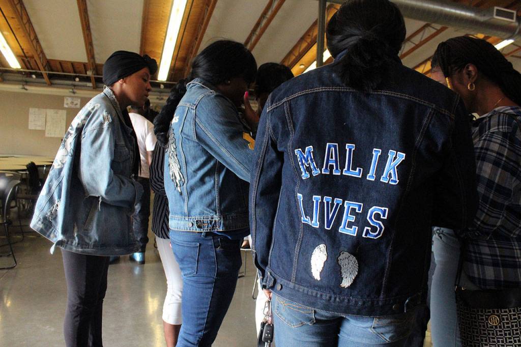 Alexis Broussard wears a jacket that says Malik Lives. Her son, Antonio Malik Douglas, was shot and killed in December 2018. Olivia Sullivan/staff photo