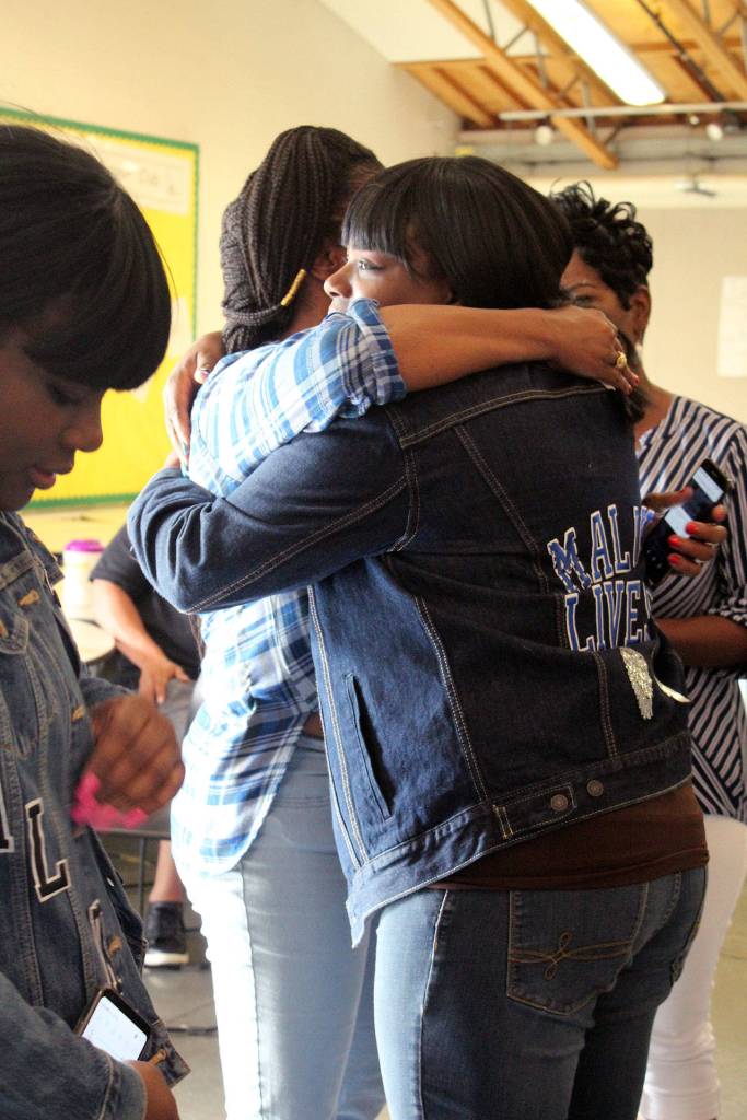 Rochelle Wilson, right, and Alexis Broussard embrace at Cameron Wilsons healing circle. Both mothers have lost a son to gun violence in the last six months. Olivia Sullivan/staff photo