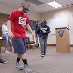 Teens learn about the dangers of intoxicated driving and attempt to walk a path while wearing Drunk Goggles. Olivia Sullivan/staff photo