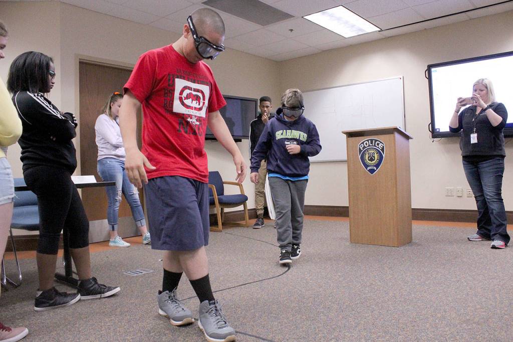 Teens learn about the dangers of intoxicated driving and attempt to walk a path while wearing Drunk Goggles. Olivia Sullivan/staff photo