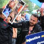 A protester of the Drag Queen Story Hour holds up erotica for families and children as they exit the event at Fairwood Library near Renton on June 27. Aaron Kunkler/Staff photo