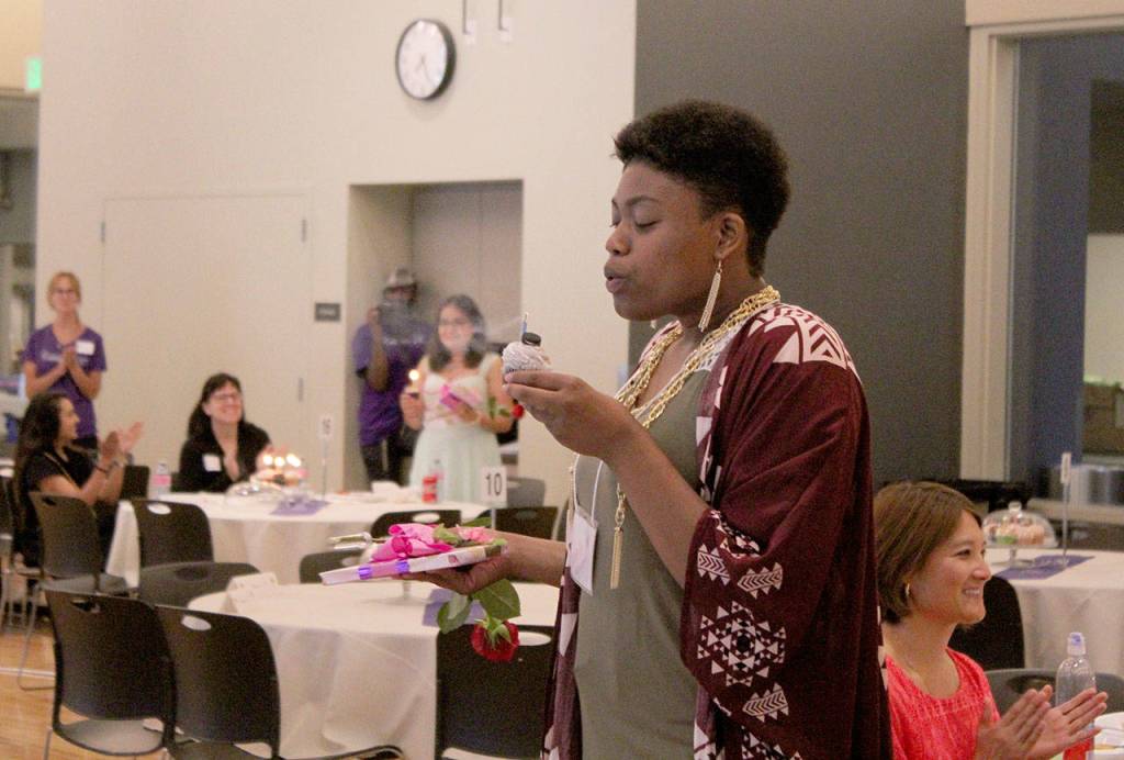 Kathie Nguyen blows out her birthday candle at Saturdays Celebrate 18! event. Olivia Sullivan/staff photo