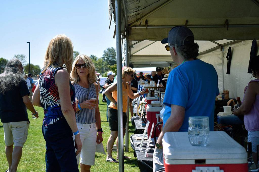 Event attendees taste one of the 20 local brews showcased at Rhythm and Brews. Haley Donwerth/staff photo