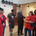 Stable Homes Federal Way attorney Knol Lowney with Virginia Ginny Ferguson and other members of Stable Homes Federal Way celebrate after a judge denies Rental Housing Association of Washingtons request for a temporary restraining order. Haley Donwerth/staff photo
