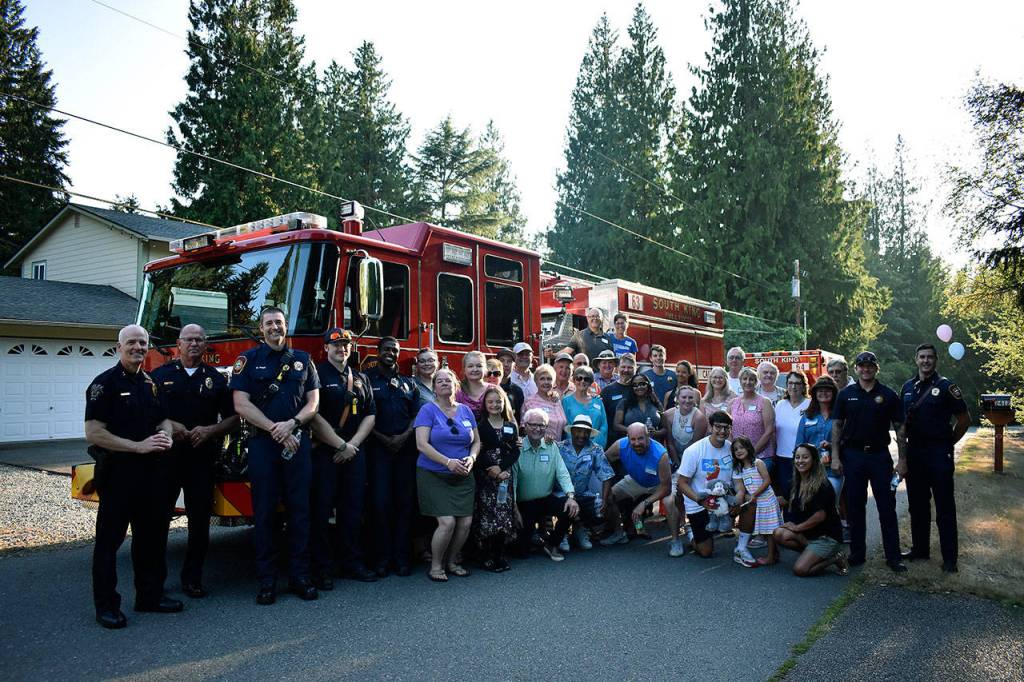 SKFR and the Federal Way Police Department stopped for a picture with some residents during National Night Out. Haley Donwerth/staff photo