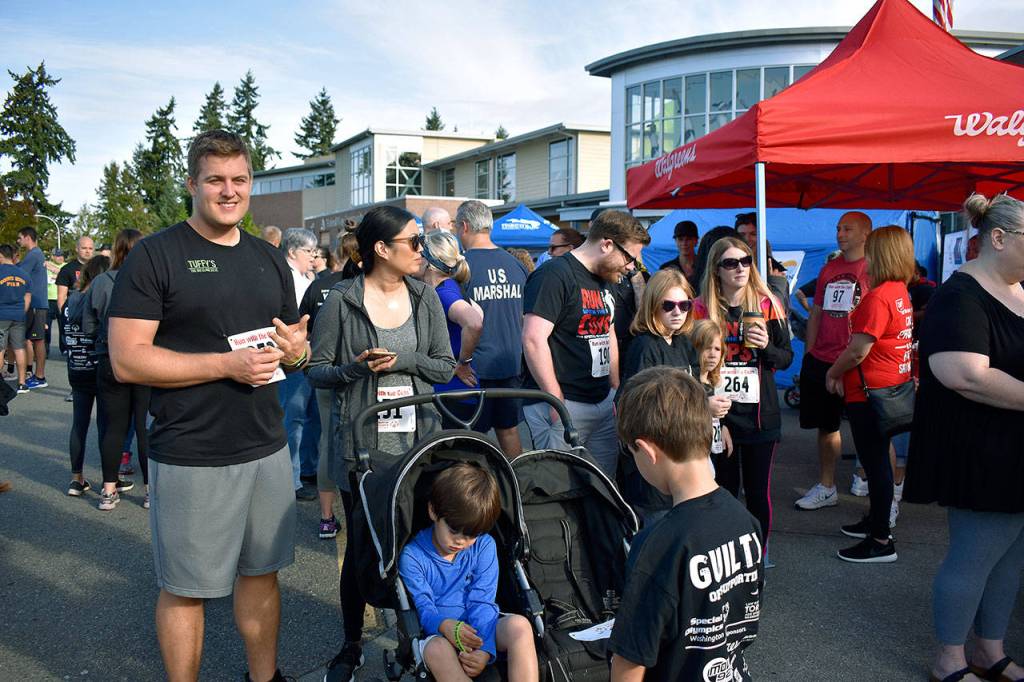 Dozens of people gathered at the start and finish line of the Run with a Cop 5K at the Federal Way Community Center Aug. 24. Haley Donwerth/staff photo