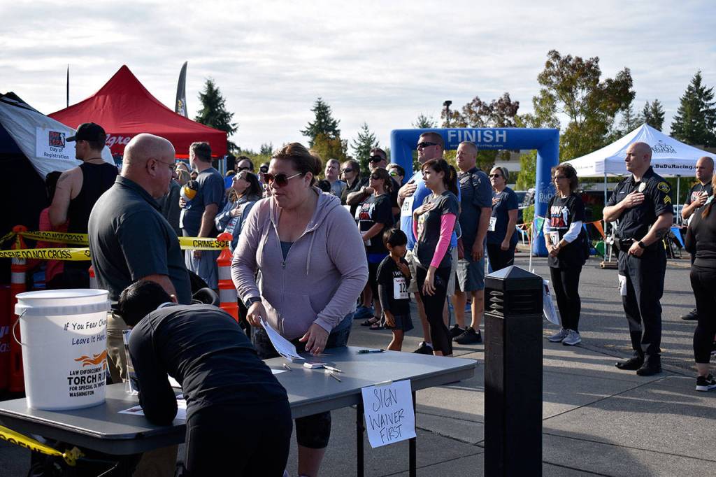 Dozens of people gathered at the start and finish line of the Run with a Cop 5K at the Federal Way Community Center Aug. 24. Haley Donwerth/staff photo