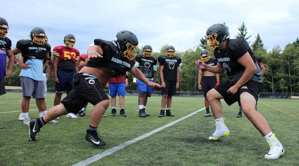 Two Thomas Jefferson football players practice defensive plays at a preseason practice on Aug. 29. Olivia Sullivan/staff photo