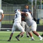 Two Decatur players battle on the field during defense drills on Saturday, Aug. 31. Olivia Sullivan/staff photo