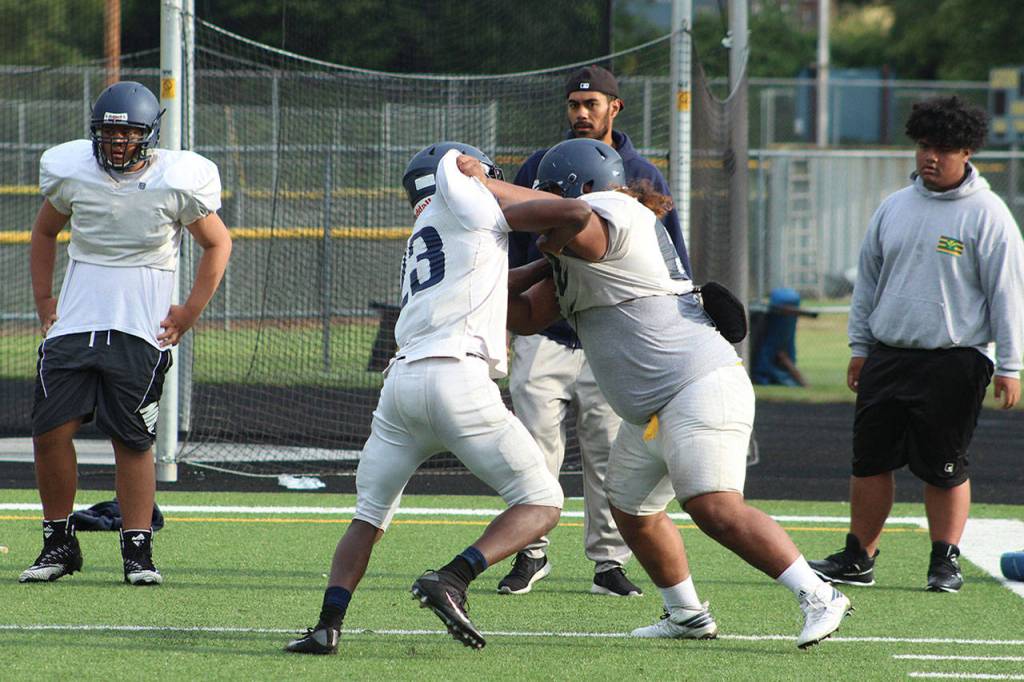Two Decatur players battle on the field during defense drills on Saturday, Aug. 31. Olivia Sullivan/staff photo