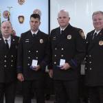 Incoming fire Chief Vic Pennington, firefighter Dean Bastin, firefighter Greg Garka, and Assistant Chief Kevin Crossen pose for a picture after awarding Bastin and Garka with Medals of Valor on Aug. 27. Olivia Sullivan/staff photo