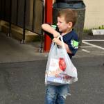 A boy holds onto a bag of food his family donated to benefit the Multi-Service Center in Federal Way. Photo courtesy of Shelley Pauls