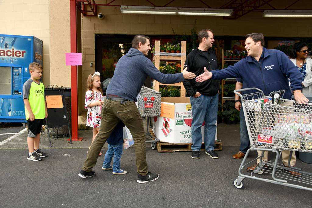 Mayor Jim Ferrell greets a resident during the Mayors Month of Concern Food Drive in front of the Grocery Outlet last week. Photo courtesy of Shelley Pauls