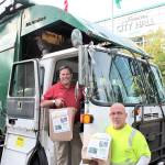 Mayor Jim Ferrell receives first food drive donations from Waste Management driver Barry Carr last week. Photo courtesy of Tyler Hemstree/City of Federal Way
