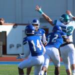 Federal Way quarterback R.J. Tausili tries to flip the ball to Calson Tiweyang as Auburn Riversides Cade Foster applies pressure during first-half action. Olivia Sullivan/staff photo
