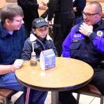 Community members sit down with a Federal Way police officer at a past Coffee with a Cop event. Photo courtesy of city of Federal Way