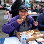 Taste of Federal Way judge Jan Novak takes a bite of her first sample dish at Saturdays event.