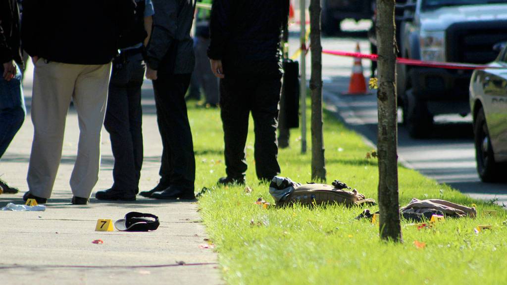 Evidence from the arrest is marked on the sidewalk along Southwest Campus Drive in Federal Way. Olivia Sullivan/staff photo