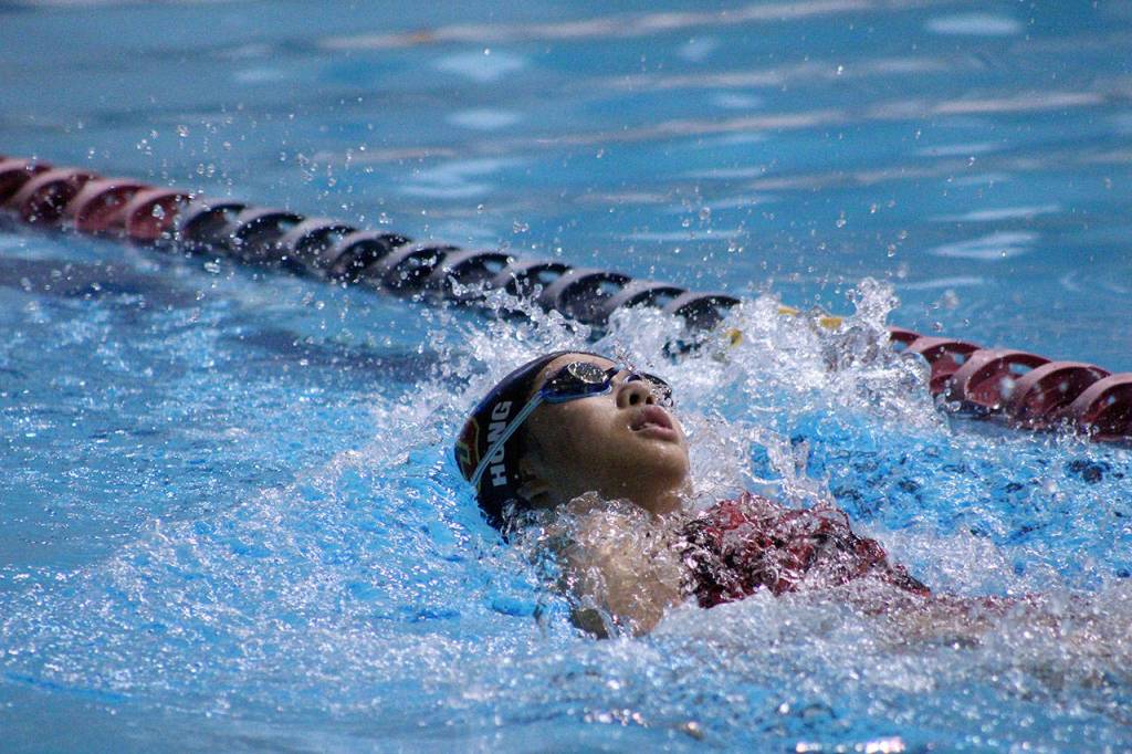 Thomas Jefferson freshman Michelle Hong glides through the pool during the 100 backstroke at the All-City meet. Olivia Sullivan/staff photo