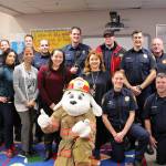 Staff of Rainier View Elementary School and members of South King Fire and Rescue pose with Sparky the Fire Dog at the Operation Warm event on Oct. 21. Olivia Sullivan/staff photo