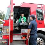 Kindergartener Mustafa Akhmedov takes a turn sitting in the fire engine on Oct. 21. Olivia Sullivan/staff photo