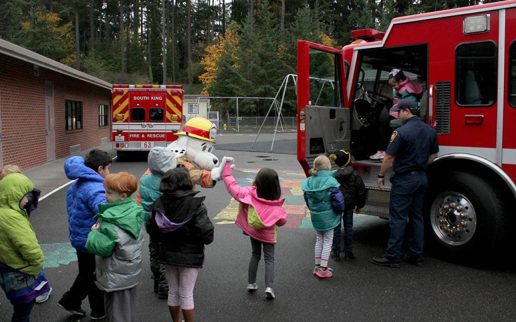 Wearing their new winter coats, kindergarteners and first graders at Rainier View had a chance to meet Sparky the Fire Dog and sit in the firetruck. Olivia Sullivan/staff photo