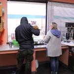 Two clients chat in the kitchen at the Federal Way Day Center as a Chihuahua named Princess looks out the window on Jan. 2, 2019. The Federal Way Mirrors Humanizing Homelessness series won a first place award in best comprehensive coverage in the Washington Newspaper Publishers Associations 2019 Better Newspaper Contest. File photo