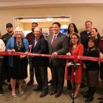 Greater Federal Way Chamber of Commerce CEO Rebecca Martin, front second from left, Mayor Jim Ferrell, middle, and Deputy Mayor Susan Honda, third from right, join members of the Brookdale Foundation House team for the ribbon cutting on Thursday, Oct. 24. Olivia Sullivan/staff photo