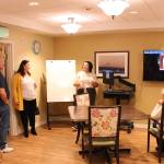 Program coordinator Angel Johnson explains Clare Bridges InTouch Technology to ribbon cutting attendees. Olivia Sullivan/staff photo