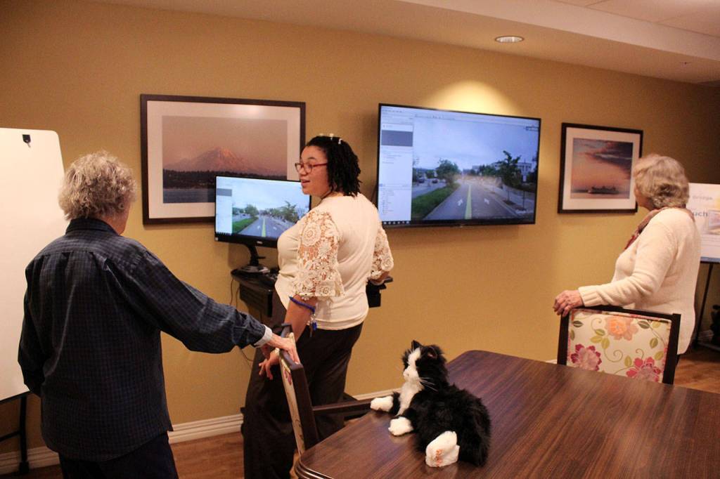 Program Coordinator Angel Johnson explains Clare Bridges InTouch Technology to ribbon cutting attendees. Olivia Sullivan/staff photo
