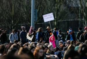 A young girl holds up a Dont Pollute I Live Here sign in the crowd during the Youth Climate Strike at Cal Anderson Park on Friday, March 15, 2019 in Seattle, Wash. (Olivia Vanni / The Herald)