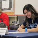 Decatur senior Ainsley Yoshizumi smiles as she signs her National Letter of Intent to attend the University of Rhode Island next fall where she will be an outfielder for the team. Olivia Sullivan/staff photo