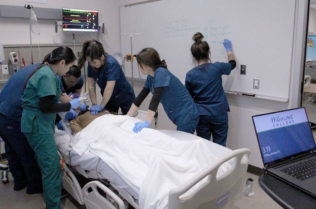 A group of Highline College students practice CPR techniques on a simulation patient on Jan. 31. Olivia Sullivan/staff photo
