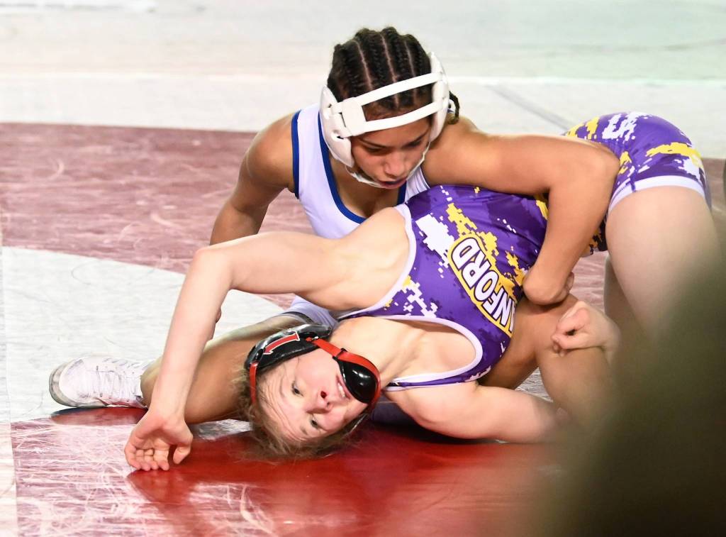 Federal Way sophomore wrestler Kayla McKinley-Johnson, top, tangles with two-time defending champion Taylor Wilson of Hanford in overtime for the 100-pound 4A title at Mat Classic XXXII in the Tacoma Dome on Saturday night. RACHEL CIAMPI, Reporter