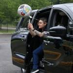 A family member leans out of the car to snap a photo of a Todd Beamer High School senior at the FWPS virtual graduation walk recording on May 20. Olivia Sullivan/staff photo