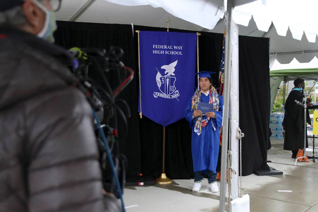 A Federal Way High School senior waits for directions from the videographer at the districts virtual graduation walk recording on May 20. Olivia Sullivan/staff photo
