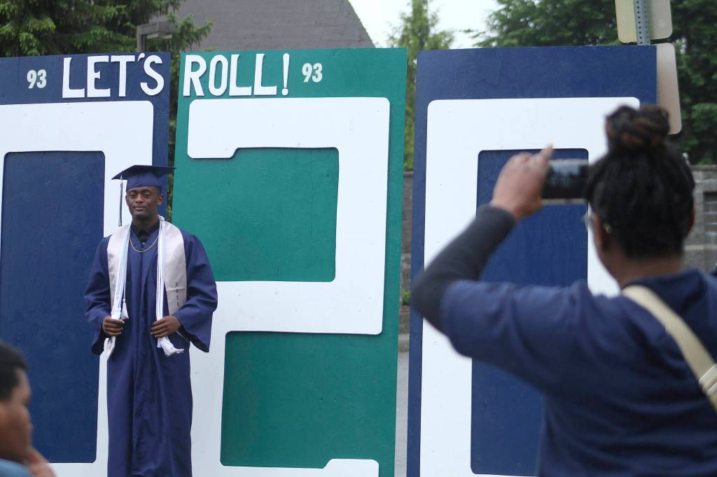 Brycen Dillworth poses in front of a Todd Beamer High School decoration while his family takes photos on May 20. Olivia Sullivan/staff photo