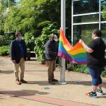State Sen. Claire Wilson (far left) and Federal Way Mayor Jim Ferrell watch as Allison Taylor holds part of the pride flag as it is raised on a flagpole outside of City Hall on Monday, June 1. Olivia Sullivan/staff photo